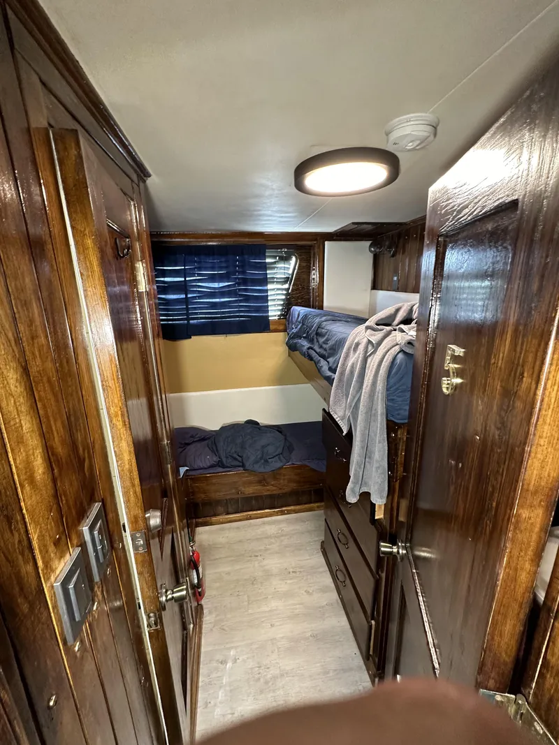 Slide: The Image of Interior of a 1965 custom dive boat with wooden bunk beds and cozy cabin space. - 14