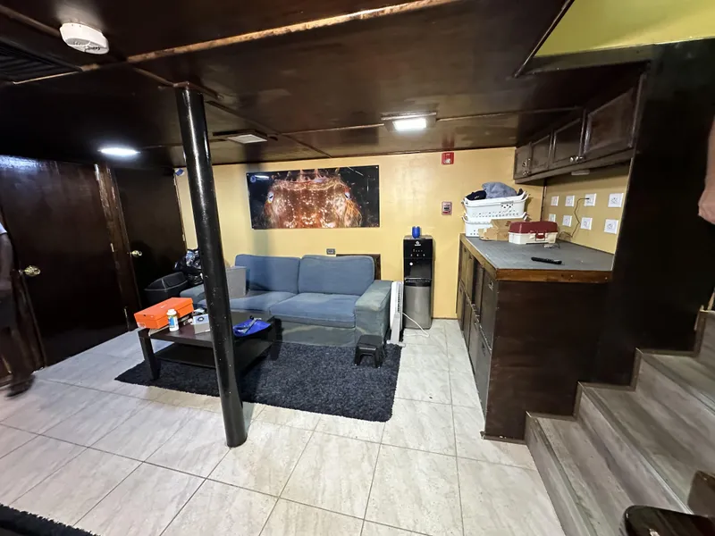 Slide: The Image of Interior of a 1965 custom dive boat with cozy seating and kitchenette. - 19