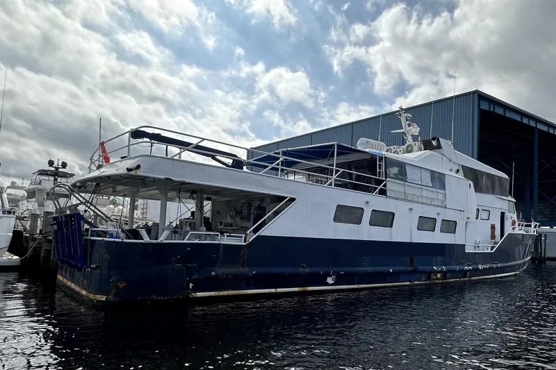 Slide: The Image of Custom 1965 dive boat docked at marina under cloudy sky. - 2