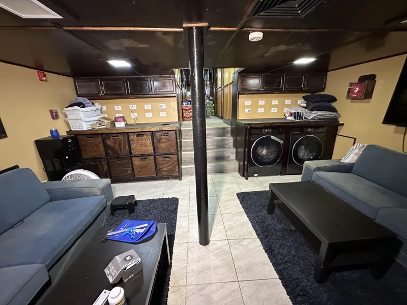 Slide: The Image of Interior of a 1965 custom dive boat with seating, storage, and laundry facilities. - 24