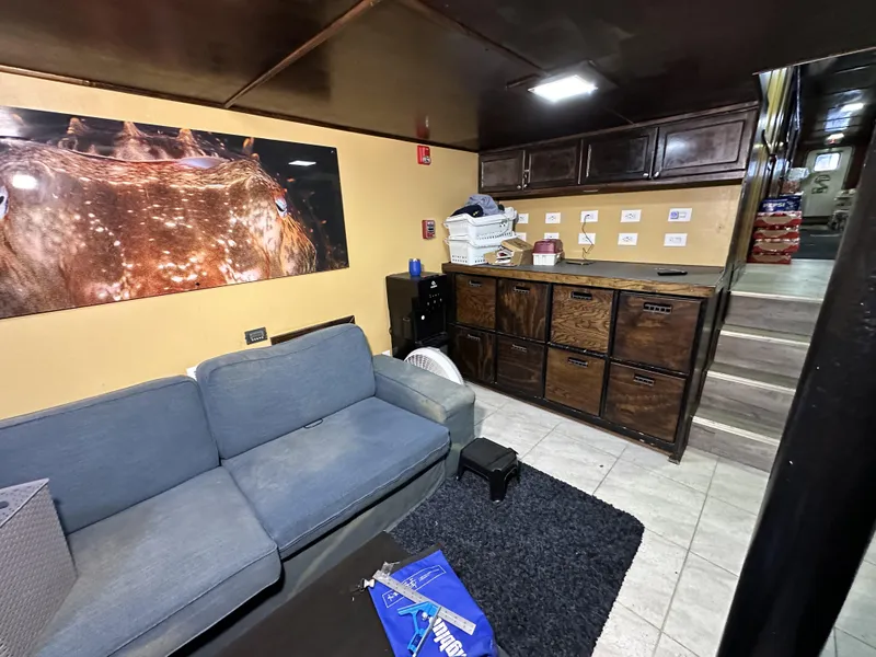 Slide: The Image of Interior of a 1965 custom dive boat with cozy seating and storage. - 26