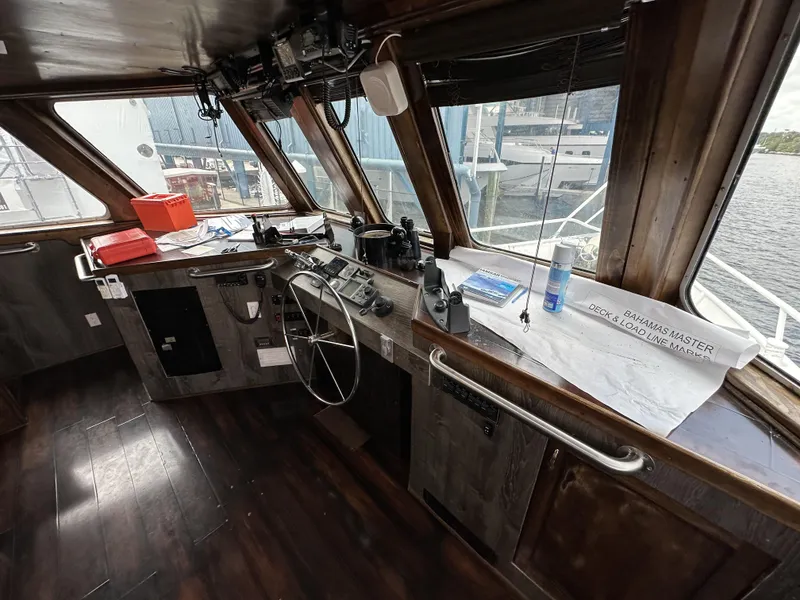 Slide: The Image of Pilothouse interior of a 1965 custom dive boat with navigation equipment and wooden flooring. - 31