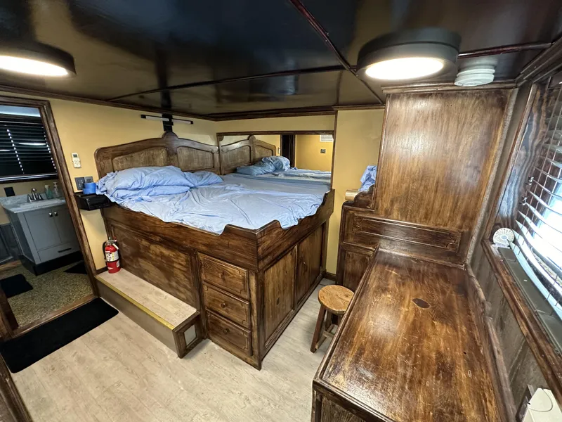 Slide: The Image of Vintage 1965 custom dive boat cabin with wooden furnishings and cozy bed setup. - 34