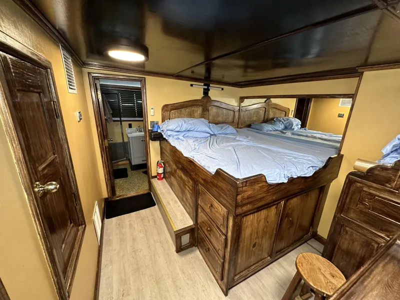 Slide: The Image of Interior of a 1965 custom dive boat with wooden furnishings and a cozy bed. - 35