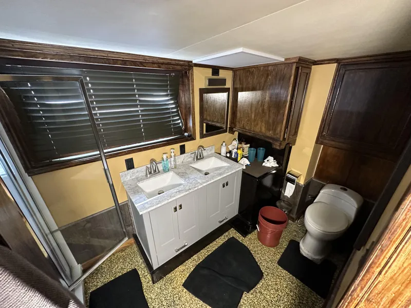 Slide: The Image of Luxurious bathroom on a 1965 custom dive boat with dual sinks and modern amenities. - 36