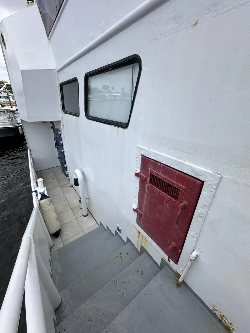 Slide: The Image of 1965 Custom Dive Boat with red hatch, side view, docked. - 37