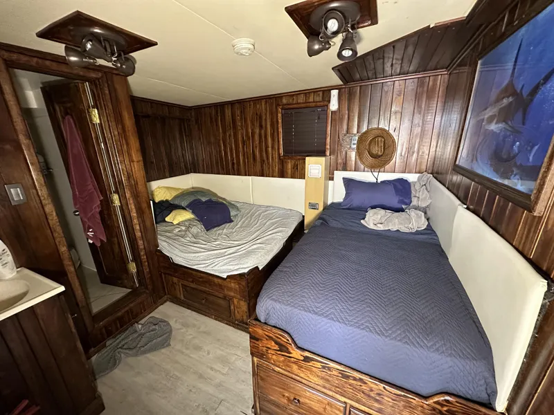 Slide: The Image of Cozy cabin interior on a 1965 custom dive boat with wooden paneling and twin beds. - 38
