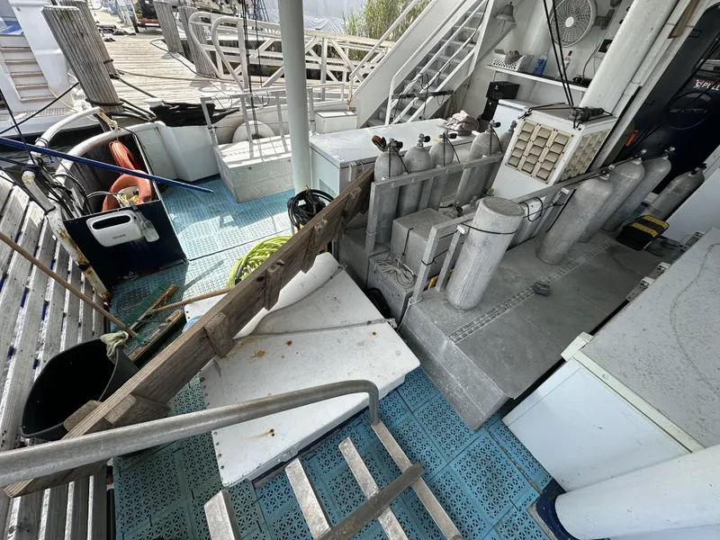 Slide: The Image of 1965 custom dive boat deck with scuba tanks and equipment. - 4