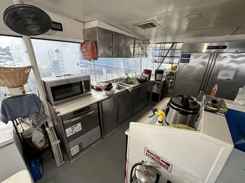 Slide: The Image of Interior of a 1965 custom dive boat kitchen with appliances and storage. - 40