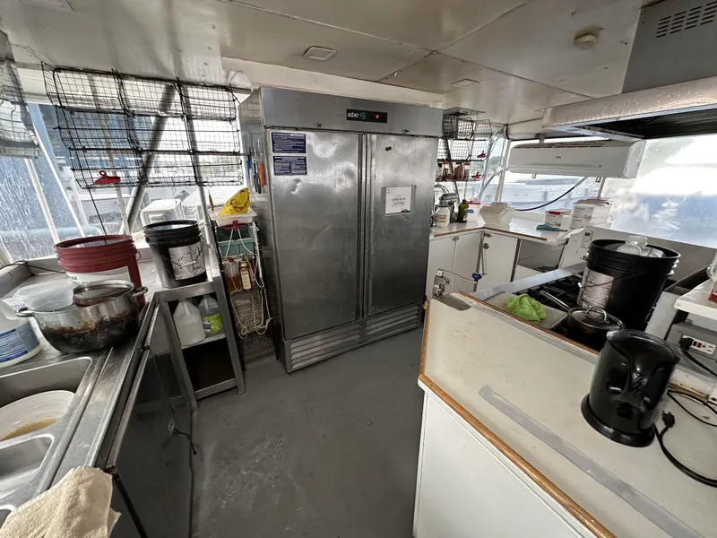 Slide: The Image of Interior of a 1965 custom dive boat kitchen with stainless steel appliances. - 41