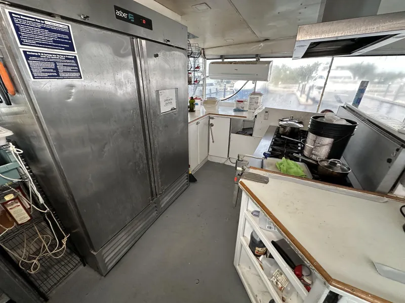 Slide: The Image of Interior of a 1965 custom dive boat kitchen with stainless steel appliances and cooking area. - 42