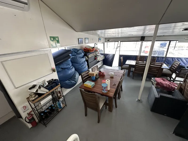 Slide: The Image of Interior of a 1965 custom dive boat with dining area and storage. - 45