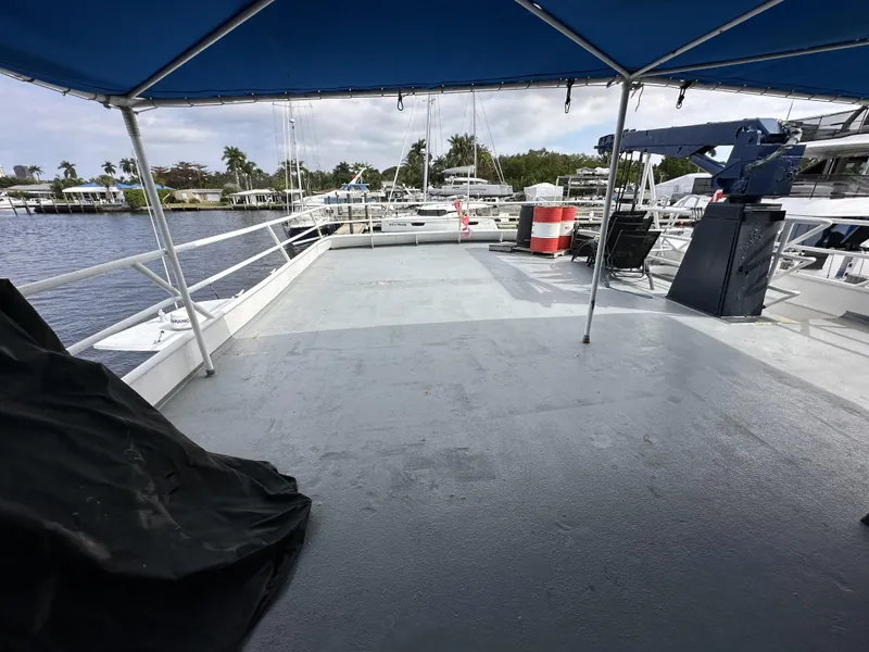 Slide: The Image of Open deck of a 1965 custom dive boat with canopy and waterfront view. - 47