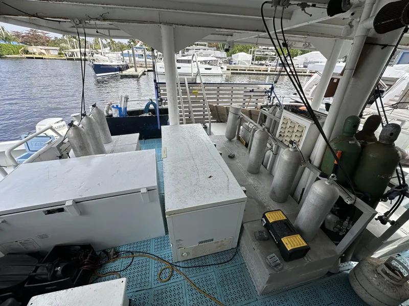 Slide: The Image of Custom 1965 dive boat with scuba tanks and equipment docked at a marina. - 5