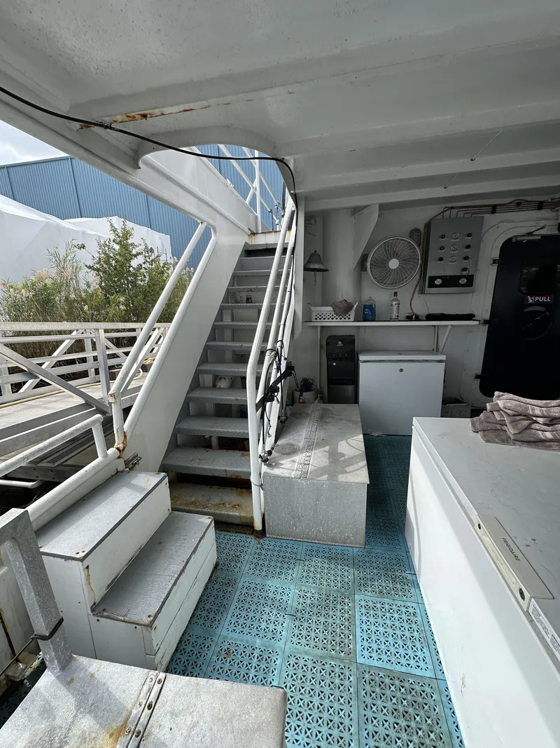 Slide: The Image of Interior of a 1965 custom dive boat with stairs, storage, and equipment. - 7