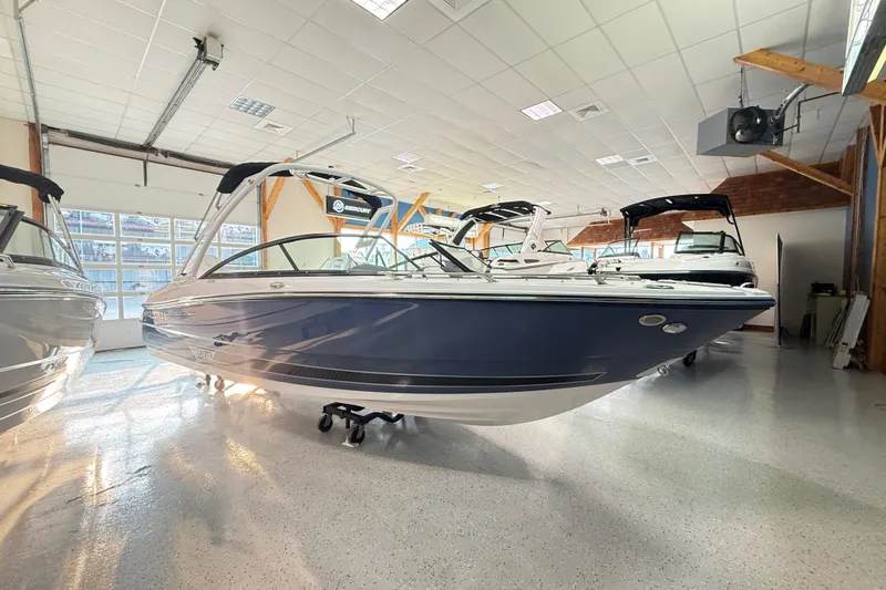 Slide: The Image of 2025 Monterey 235SS Super Sport boat displayed in a showroom. - 2
