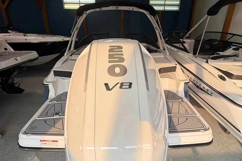 Slide: The Image of 2025 Monterey 235SS Super Sport boat with V8 engine, displayed indoors. - 6