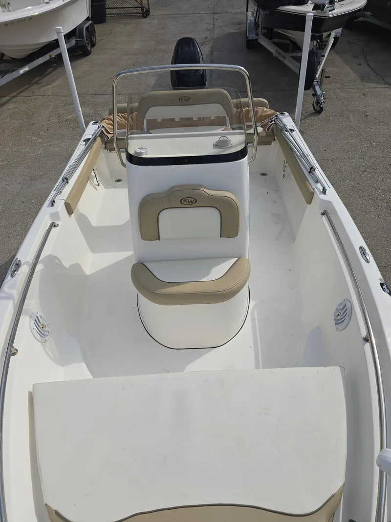 Slide: The Image of 2020 Key West 189 FS boat interior with seating and console, parked on a trailer. - 11