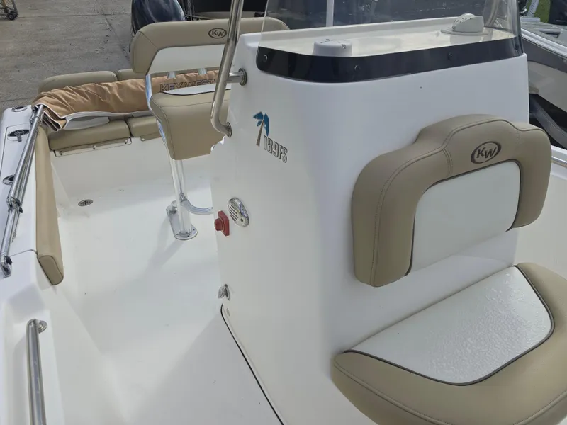 Slide: The Image of 2020 Key West 189 FS boat interior with beige seating and console. - 12