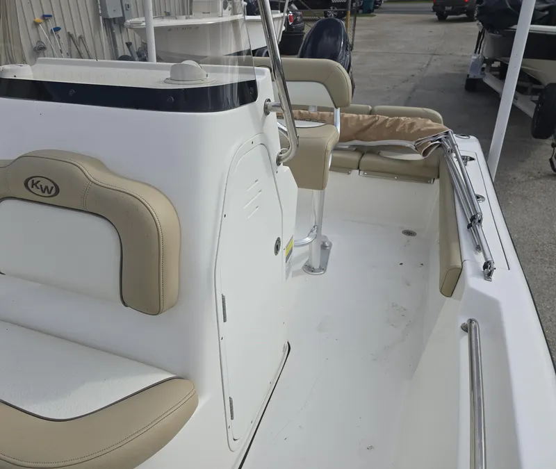 Slide: The Image of 2020 Key West 189 FS boat interior with beige seating and console. - 13