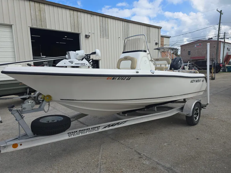 Slide: The Image of 2020 Key West 189 FS boat on trailer, parked outside a warehouse. - 5