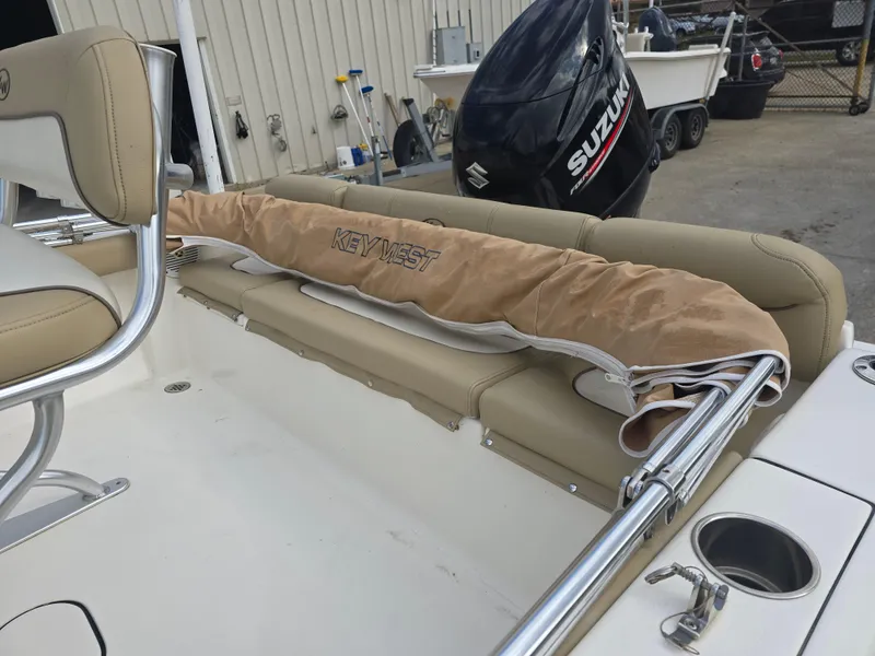 Slide: The Image of 2020 Key West 189 FS boat interior with beige seating and Suzuki outboard motor. - 6