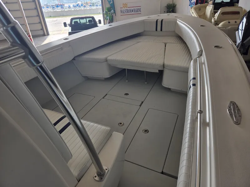 Slide: The Image of 2008 Contender 33 Tournament boat interior with cushioned seating and storage compartments. - 10