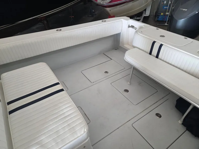 Slide: The Image of 2008 Contender 33 Tournament boat interior with white seating and storage compartments. - 12