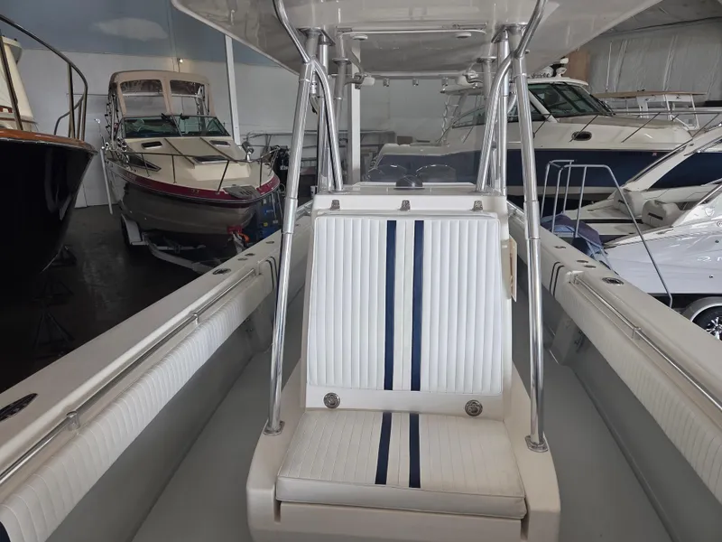 Slide: The Image of 2008 Contender 33 Tournament boat interior with striped seating in a showroom. - 13
