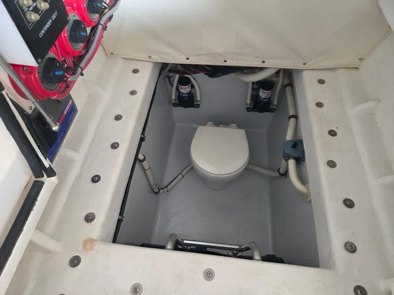 Slide: The Image of 2008 Contender 33 Tournament boat interior with marine toilet and control panel. - 14