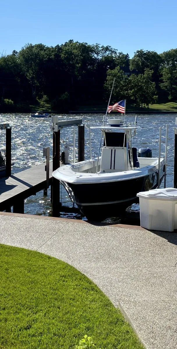 Slide: The Image of 2008 Contender 33 Tournament boat docked by a scenic riverside. - 17