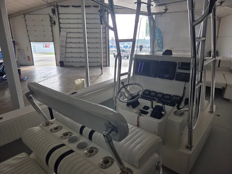 Slide: The Image of 2008 Contender 33 Tournament boat interior with steering console and seating in a garage. - 18