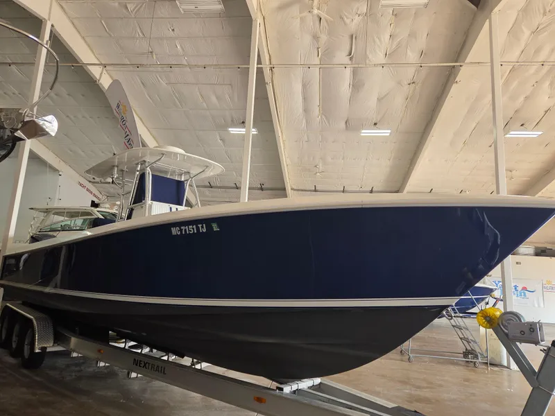 Slide: The Image of 2008 Contender 33 Tournament boat on trailer in indoor storage facility. - 2