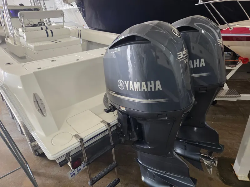 Slide: The Image of 2008 Contender 33 Tournament boat with dual Yamaha outboard engines in a showroom. - 4