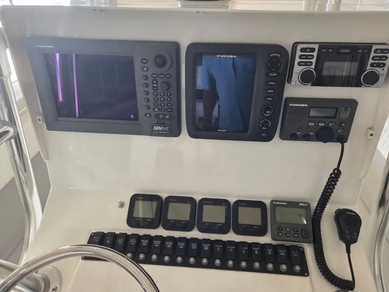 Slide: The Image of Control panel of a 2008 Contender 33 Tournament boat with navigation and communication equipment. - 7