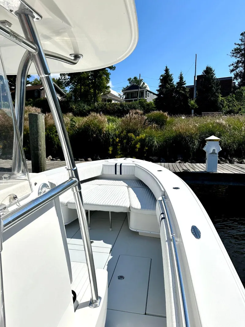 Slide: The Image of 2008 Contender 33 Tournament boat docked near lush greenery. - 9