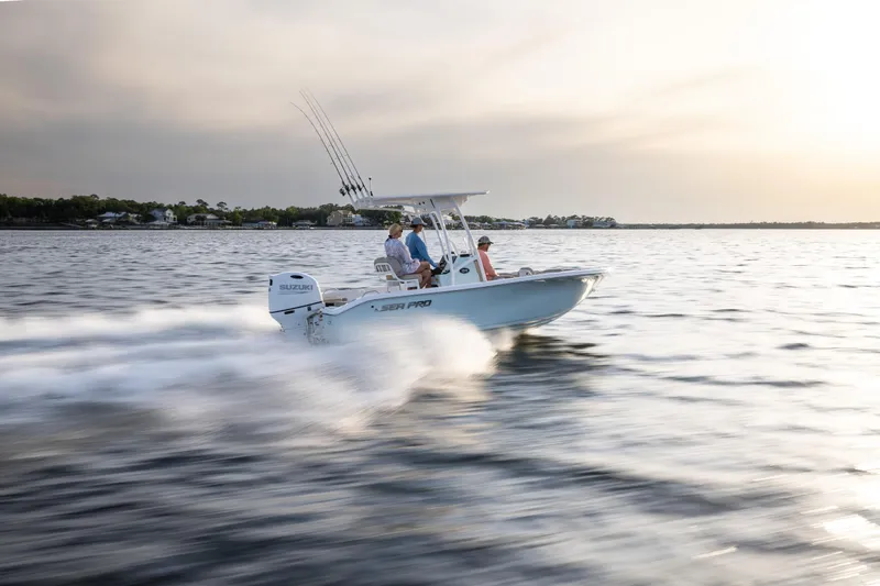 Slide: The Image of 2025 Sea Pro 202 Center Console boat cruising on open water at sunset. - 3