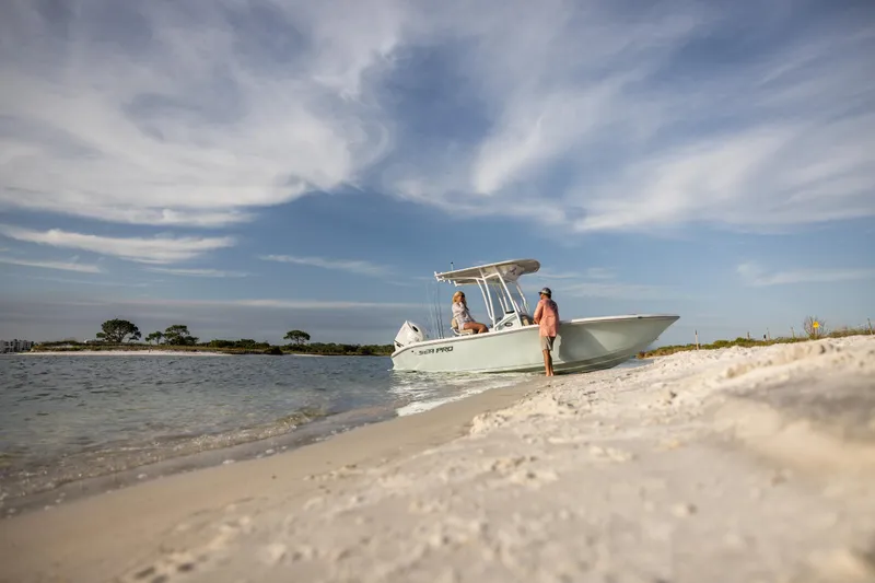 Slide: The Image of 2025 Sea Pro 202 Center Console boat on sandy beach under blue sky. - 6