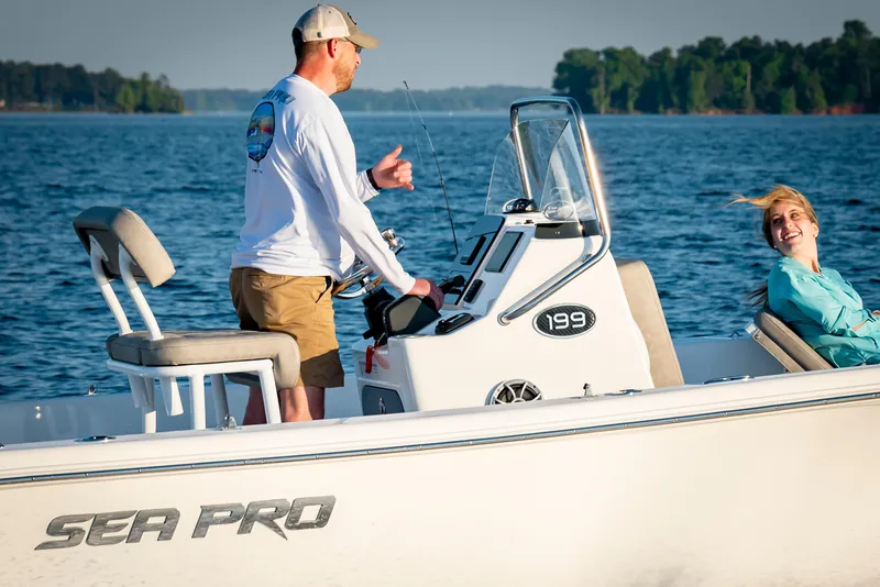 Slide: The Image of 2025 Sea Pro 202 Center Console boat on water with two people enjoying a sunny day. - 8