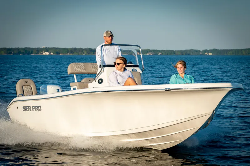 Slide: The Image of 2025 Sea Pro 202 Center Console boat cruising on a calm lake with three passengers. - 9