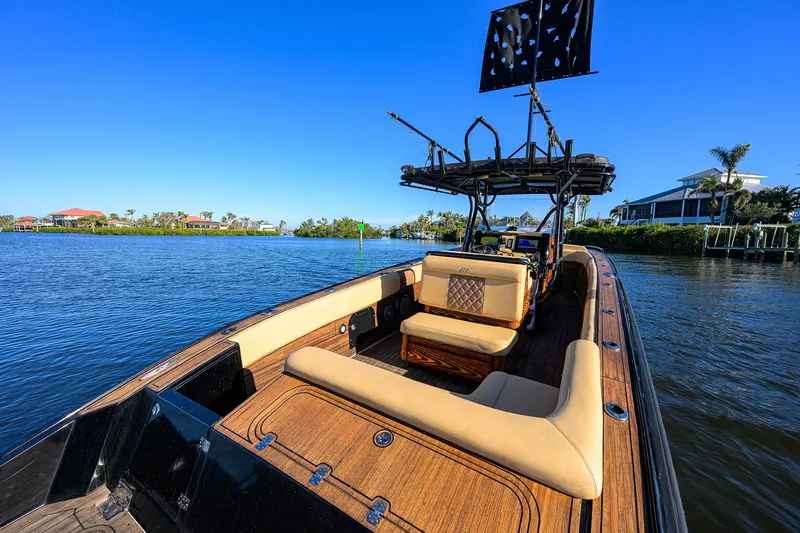 Slide: The Image of 2005 Midnight Express 39S Open boat on a sunny day, featuring luxurious seating and scenic waterfront. - 23