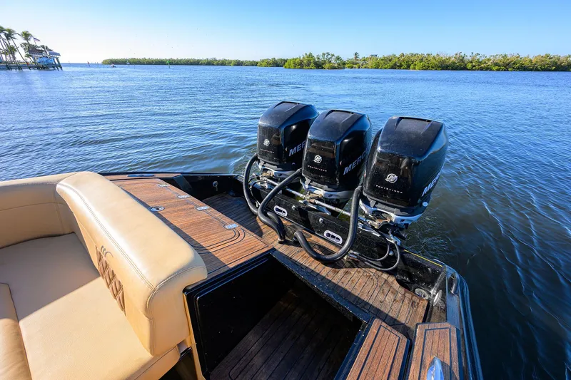 Slide: The Image of 2005 Midnight Express 39S Open boat with triple Mercury engines on a calm waterway. - 25