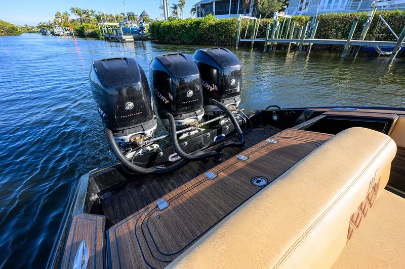 Slide: The Image of 2005 Midnight Express 39S Open boat with triple Mercury outboard engines on a sunny day. - 26