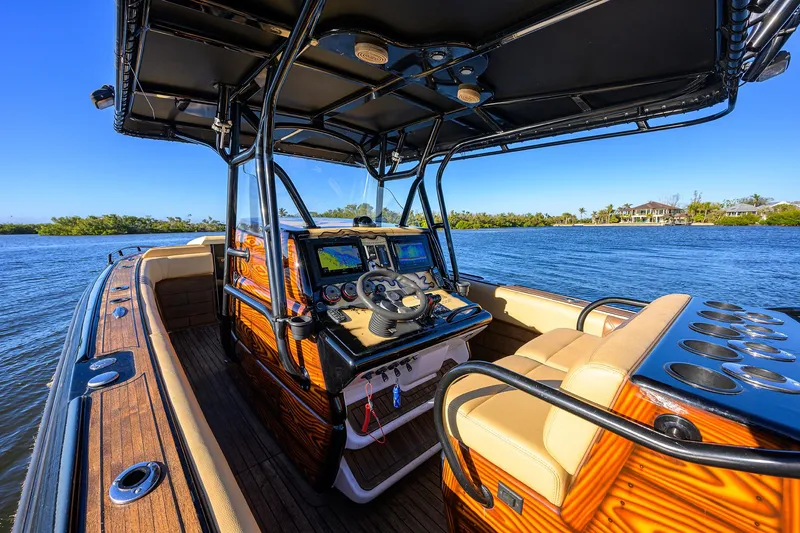 Slide: The Image of 2005 Midnight Express 39S Open boat interior with steering console on a sunny day. - 27