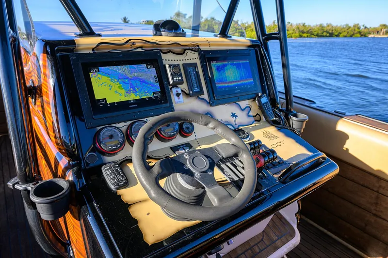 Slide: The Image of 2005 Midnight Express 39S Open boat dashboard with navigation screens and steering wheel. - 28