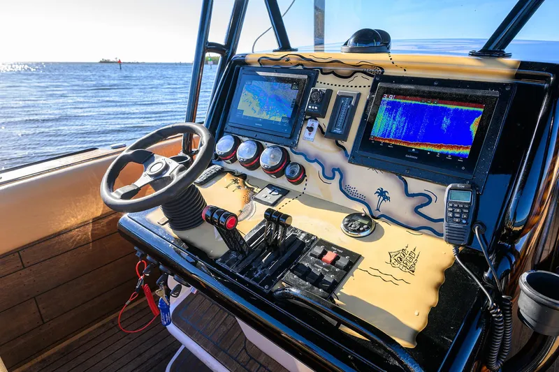 Slide: The Image of Control panel of a 2005 Midnight Express 39S Open boat with navigation screens. - 30