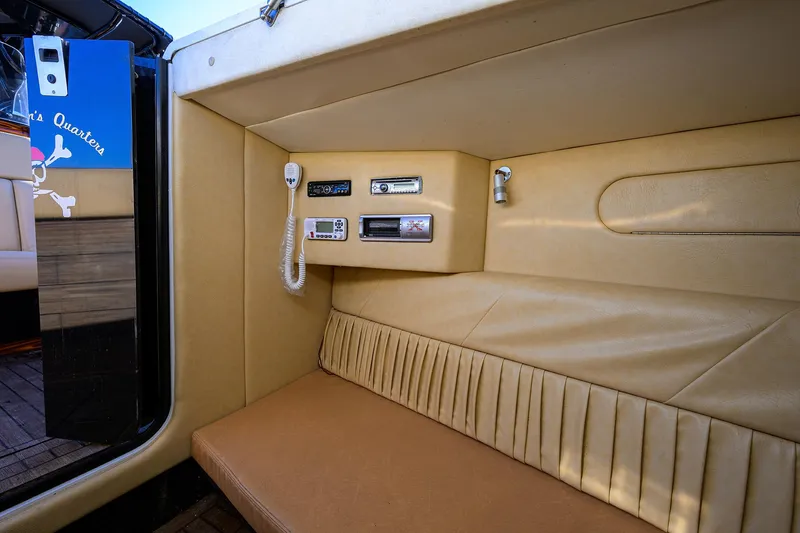 Slide: The Image of 2005 Midnight Express 39S Open cabin interior with beige seating and communication equipment. - 35