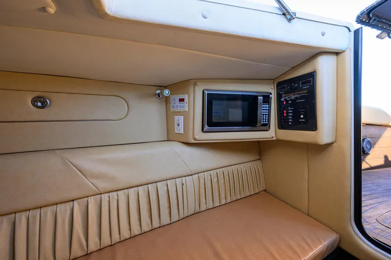 Slide: The Image of Interior of 2005 Midnight Express 39S Open boat with microwave and control panel. - 36