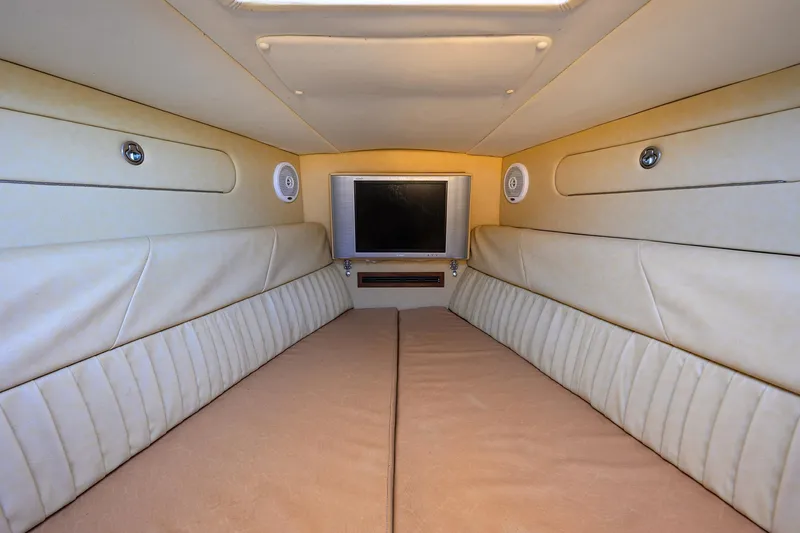 Slide: The Image of Interior cabin of 2005 Midnight Express 39S Open boat with beige upholstery and TV. - 37