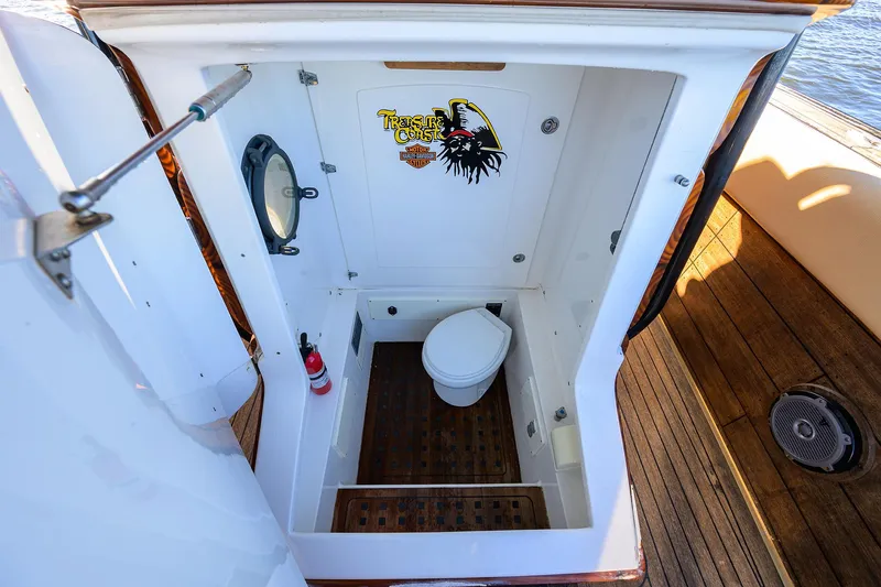 Slide: The Image of 2005 Midnight Express 39S Open boat bathroom with wooden flooring and nautical decor. - 38